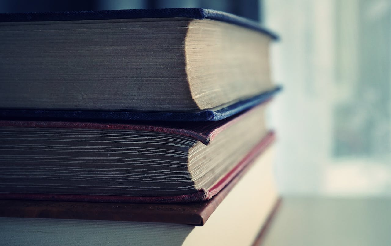 Close-up shot of stacked vintage books with soft focus on pages, perfect for educational themes.