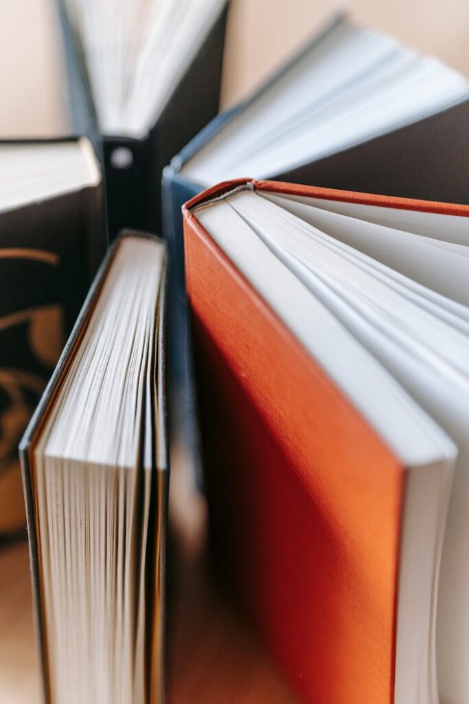 Stack of hardcover books with colorful covers in soft focus. Ideal for educational content.